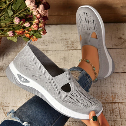 Light grey knit slip-on orthopedic shoes with side cutouts and white cushioned sole
