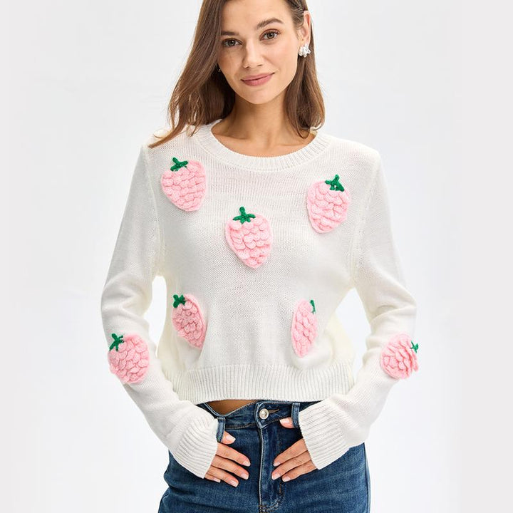 White long sleeve sweater with pink strawberry appliques and green leaves