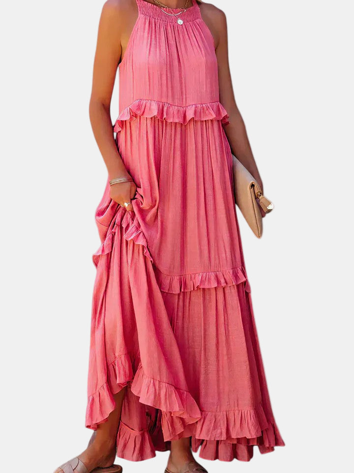 Pink tiered long dress with ruffled halter neckline and button detail at chest