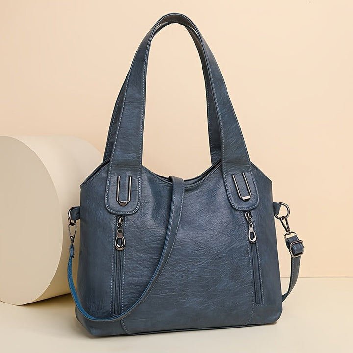 Lumi women’s classic tote bag in blue with dual handles, top zip, and adjustable crossbody strap