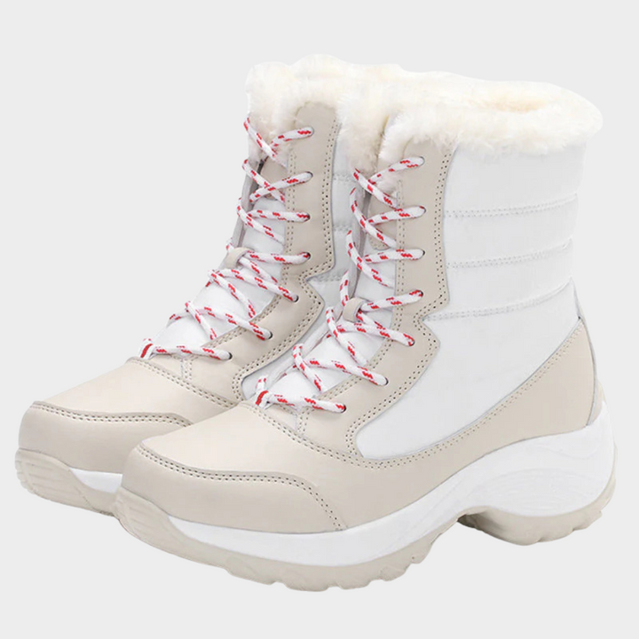 White-and-cream winter boots with lace-up front, red laces, and faux-fur collar.