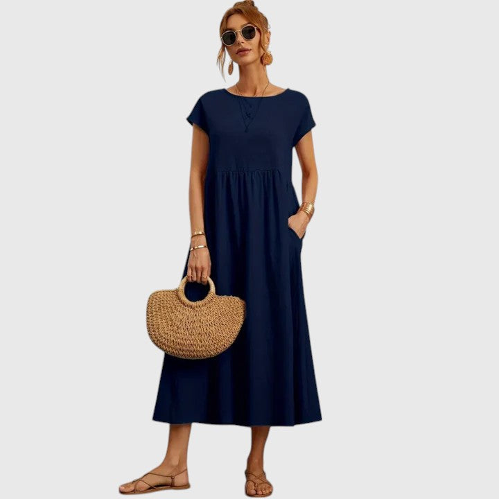Dark blue midi dress with short sleeves and gathered waist seam; relaxed fit.