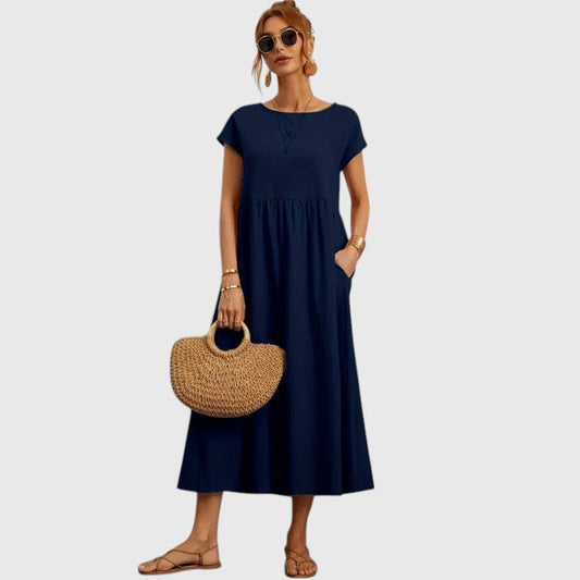 Dark blue midi dress with short sleeves and gathered waist seam; relaxed fit.