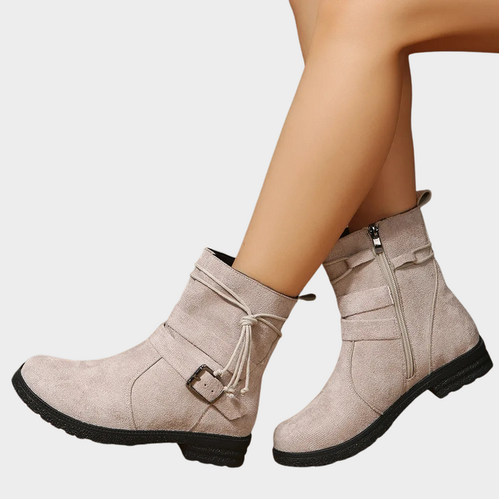 Taupe suede low-heel ankle boots with side zipper, drawstring lace, and buckle