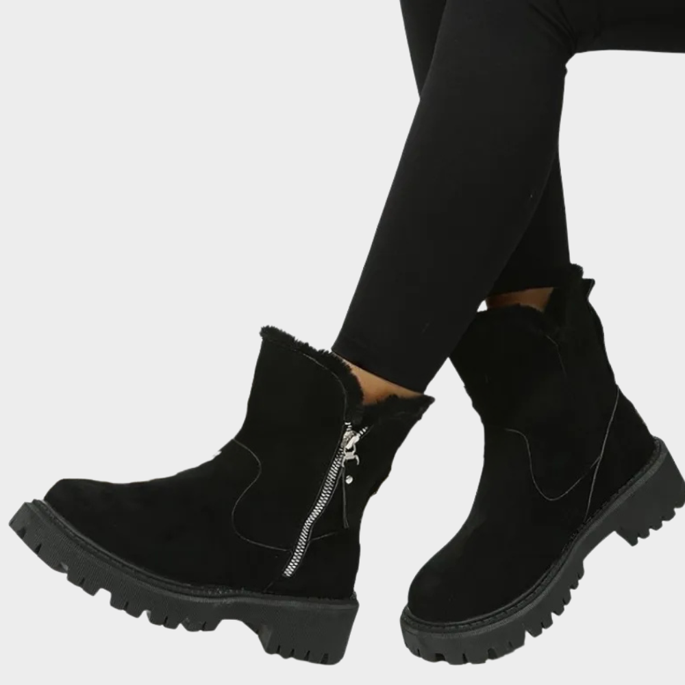 Black orthopedic boot with faux fur cuff, side zipper, and chunky lug sole