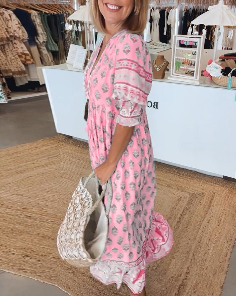Pink floral V-neck maxi dress with ruffled sleeves and tiered skirt hem