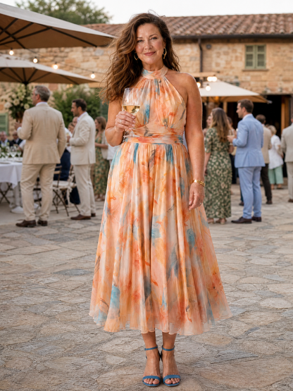 Soft halter midi dress with peach-and-blue watercolor print, high halter neck, full skirt