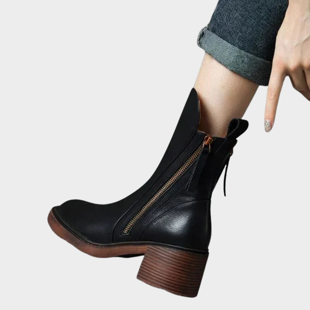 Black leather ankle heeled boot with side zip, tassel pull, chunky brown block heel