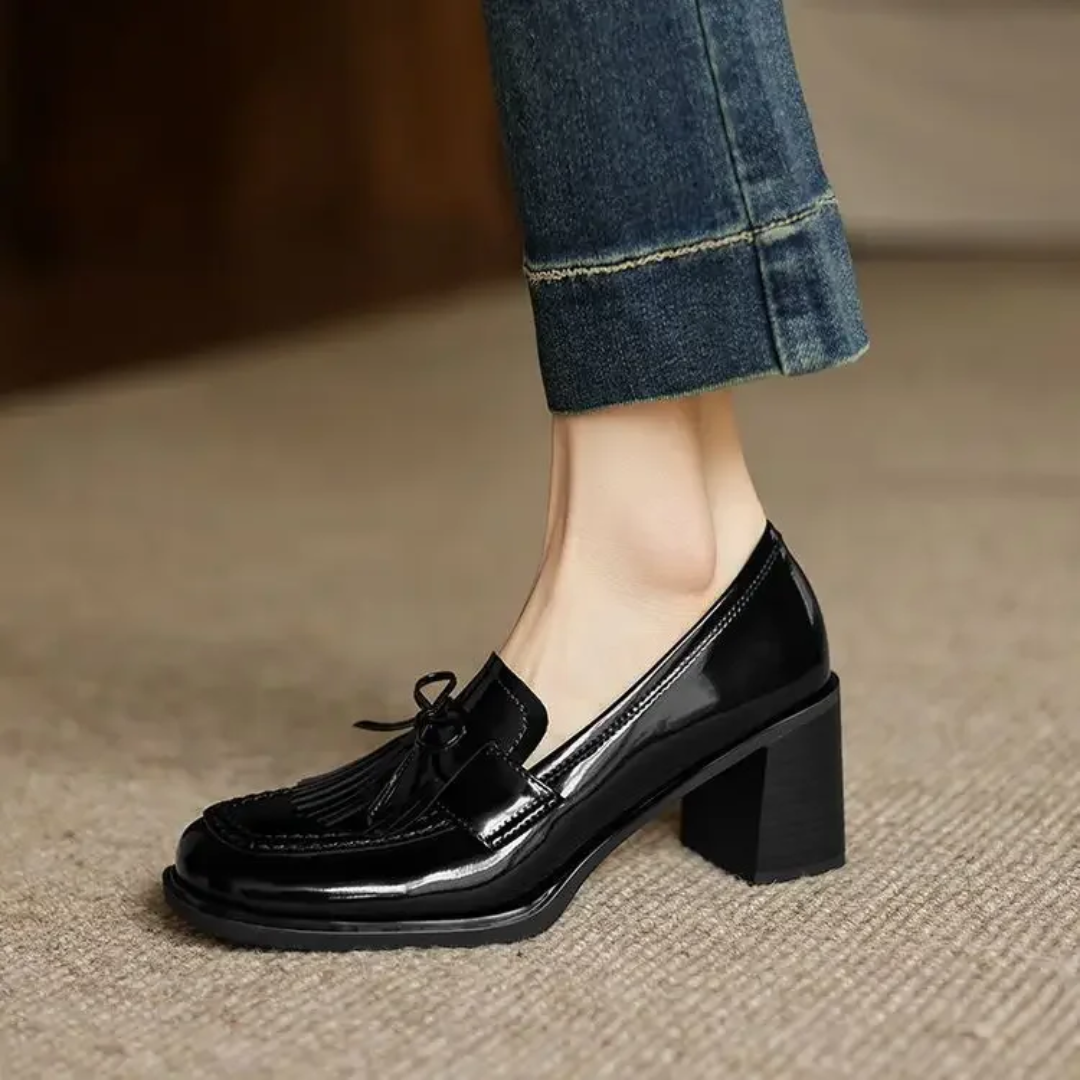 Black loafer pumps with patent finish, bow-tie detail, and block heel