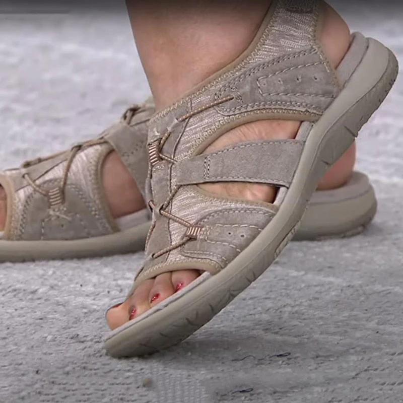 Beige orthopaedic sandals with padded straps, open toe, and thick cushioned outsole