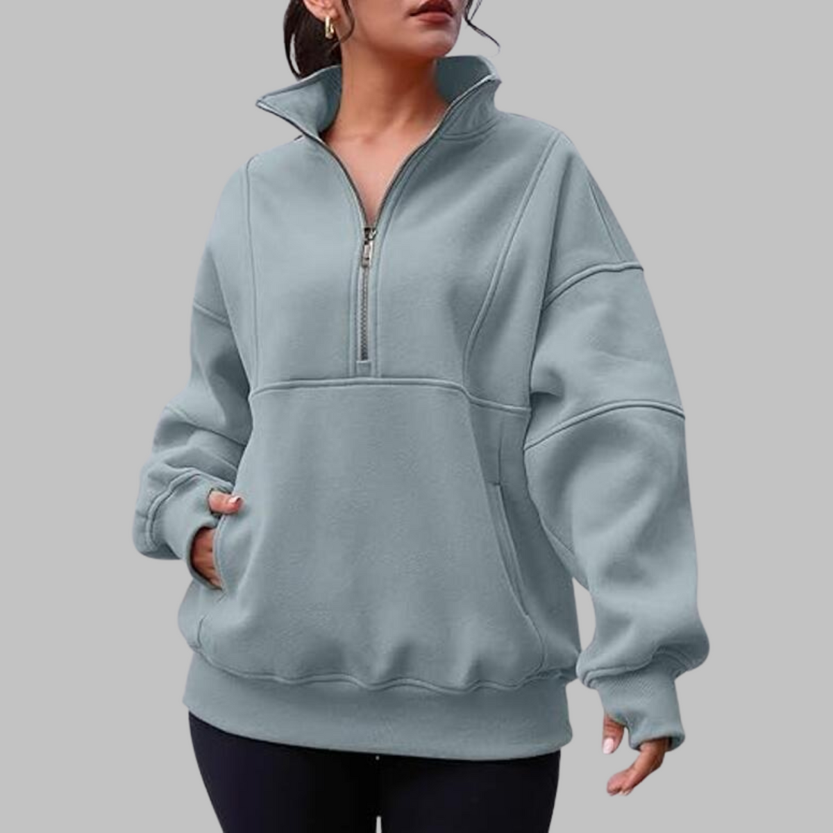 Light blue oversized half-zip long sleeve sweatshirt with ribbed cuffs, collar, and front pocket