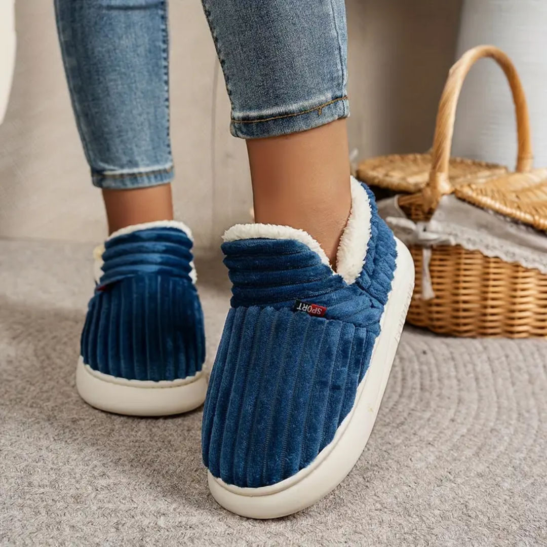 Blue comfort slippers with ribbed fabric and white fuzzy lining, slip-on style