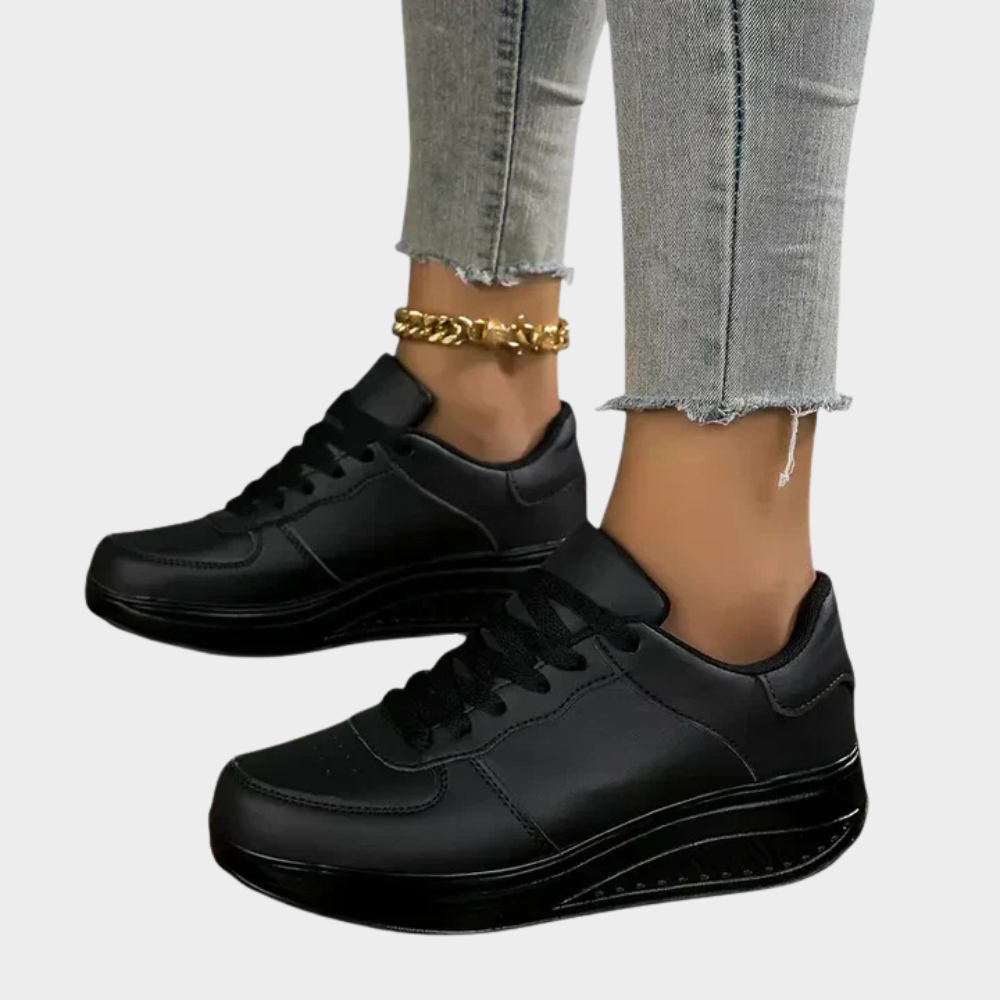 Black orthopedic sneakers with lace-up design, padded collar, and thick shock-absorbing sole
