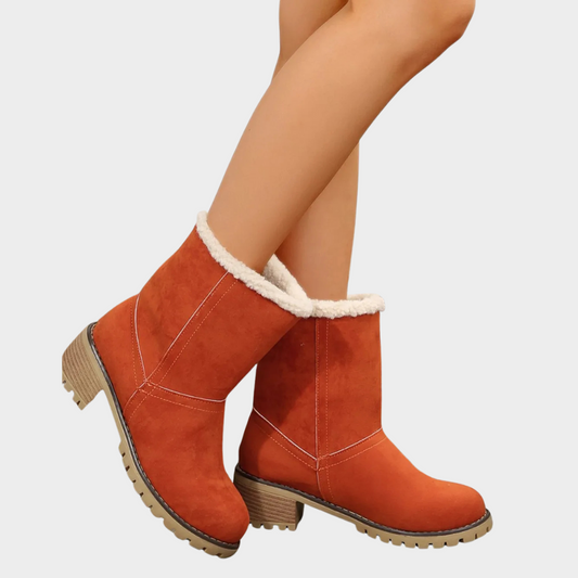 Orange suede winter boots with faux-sherpa trim, ankle height, and chunky lug sole