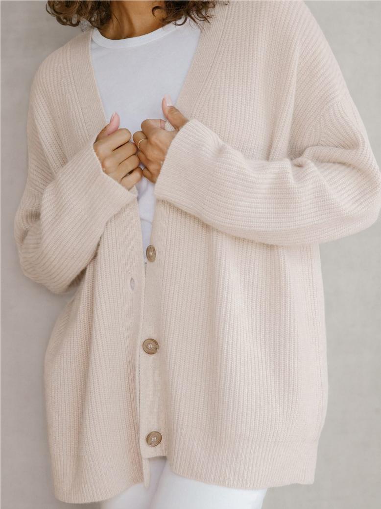 Oatmeal button-front knit cardigan with V-neck, long sleeves, ribbed texture, two-tone buttons.