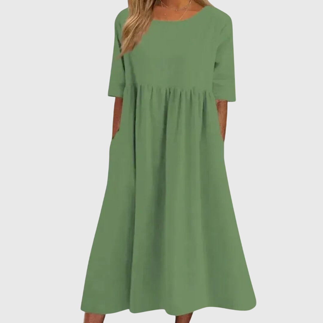 Green short-sleeve dress with round neck, gathered waist, and full midi skirt