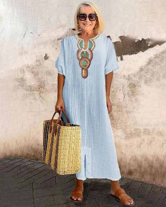 Light blue embroidered midi dress with short sleeves and central ornamental placket