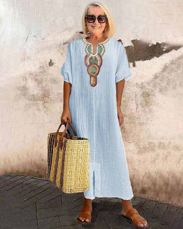 Light blue embroidered midi dress with short sleeves and central ornamental placket