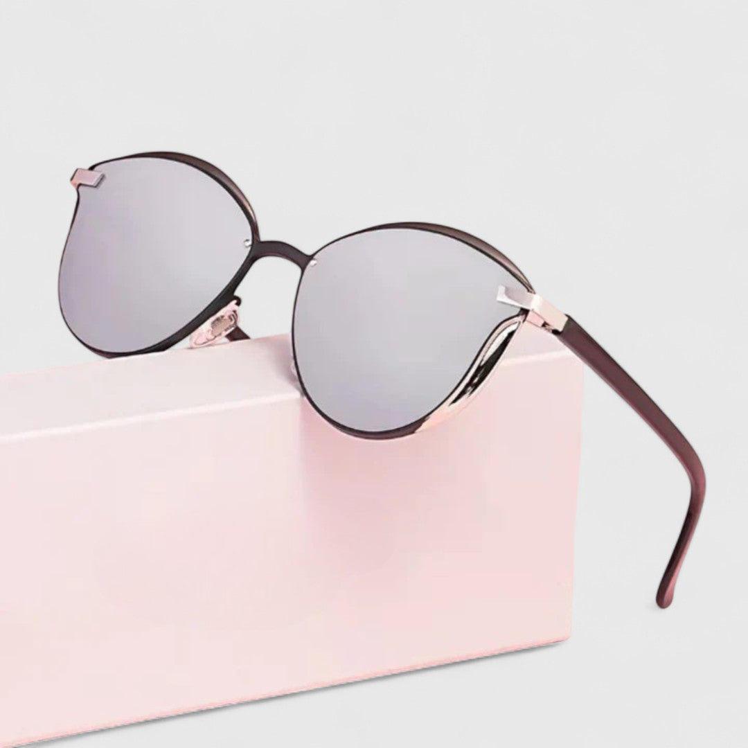 Light gray mirrored round sunglasses with dark brown frame and gold bar accents