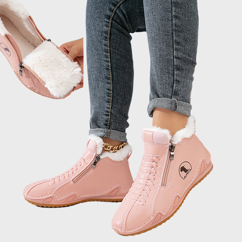 Pink ankle boots with faux fur trim, side zipper, lace-up front, and tan rubber sole.