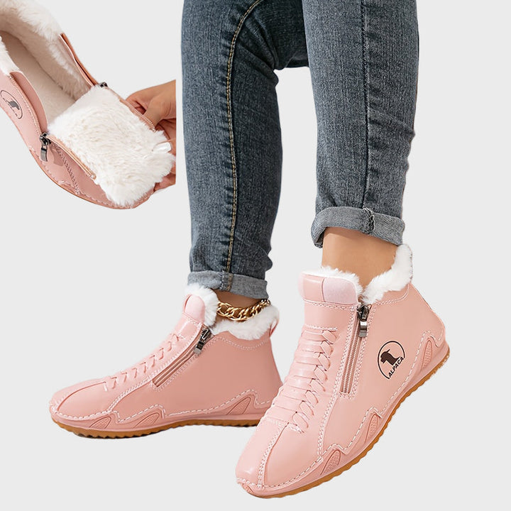 Pink ankle boots with faux fur trim, side zipper, lace-up front, and tan rubber sole.