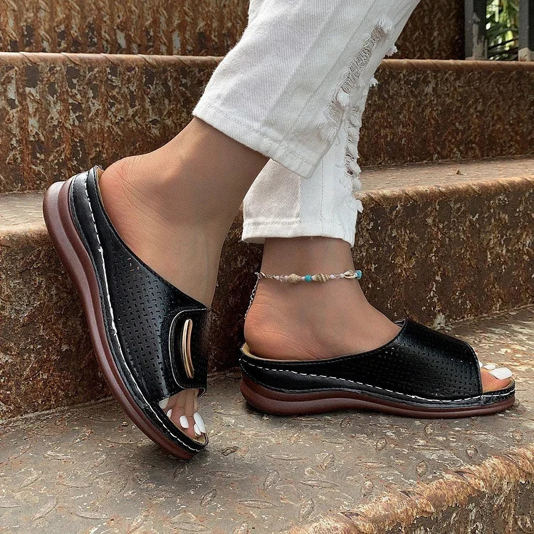 Black perforated slip-on sandals with curved metal-look bar detail