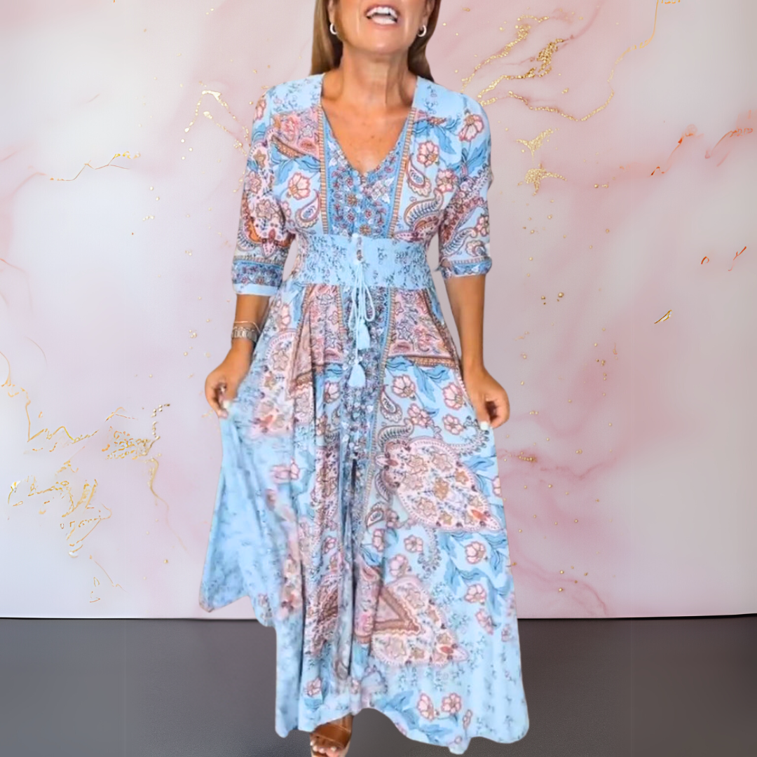 Blue paisley maxi dress, V-neck with lace-up tie, gathered waist, flowing tiered hem.