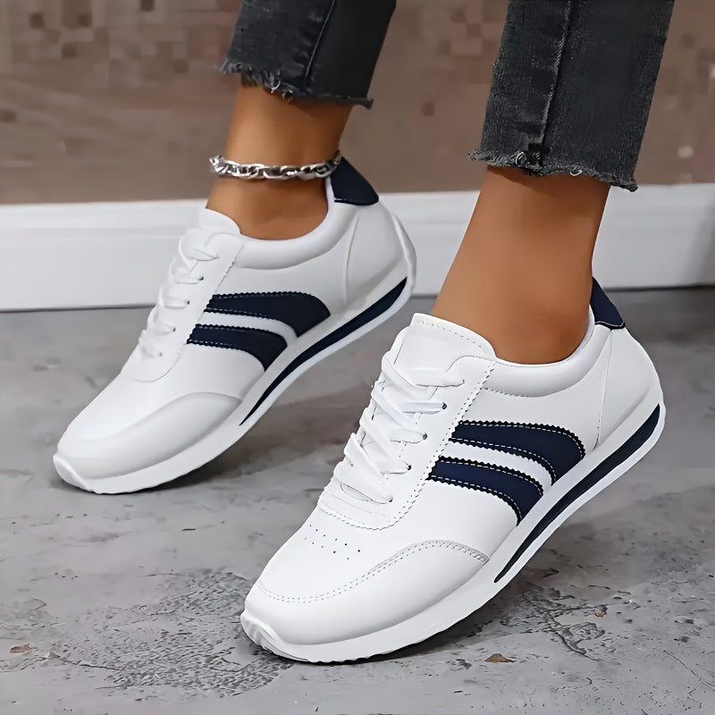 White lace-up orthopedic sneakers with navy side stripes and cushioned sole