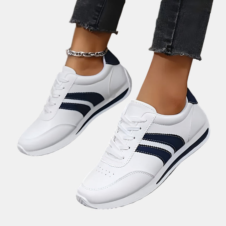 White orthopedic sneakers, front view, navy stripes and padded collar