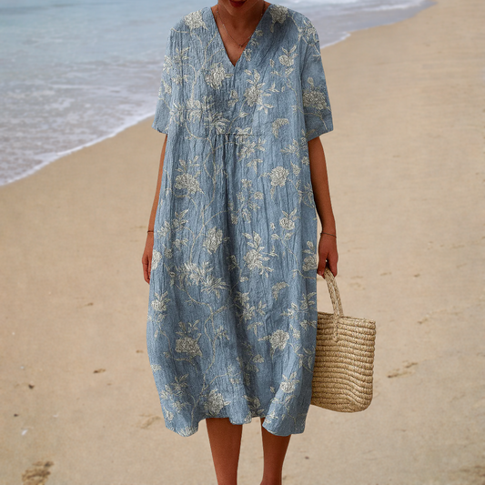 Blue printed summer dress with V-neck, short sleeves, gathered waist and flowy midi length.