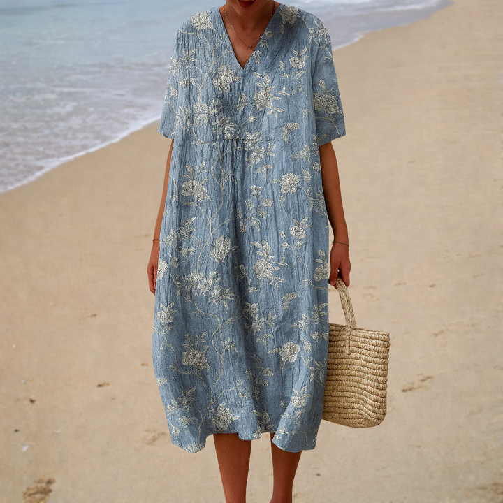 Blue printed summer dress with V-neck, short sleeves, gathered waist and flowy midi length.