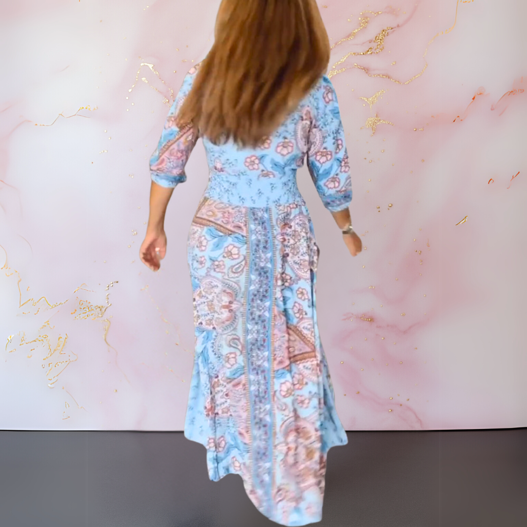 Blue paisley long summer dress, back view, V-neck placket, gathered waist, flared hem.