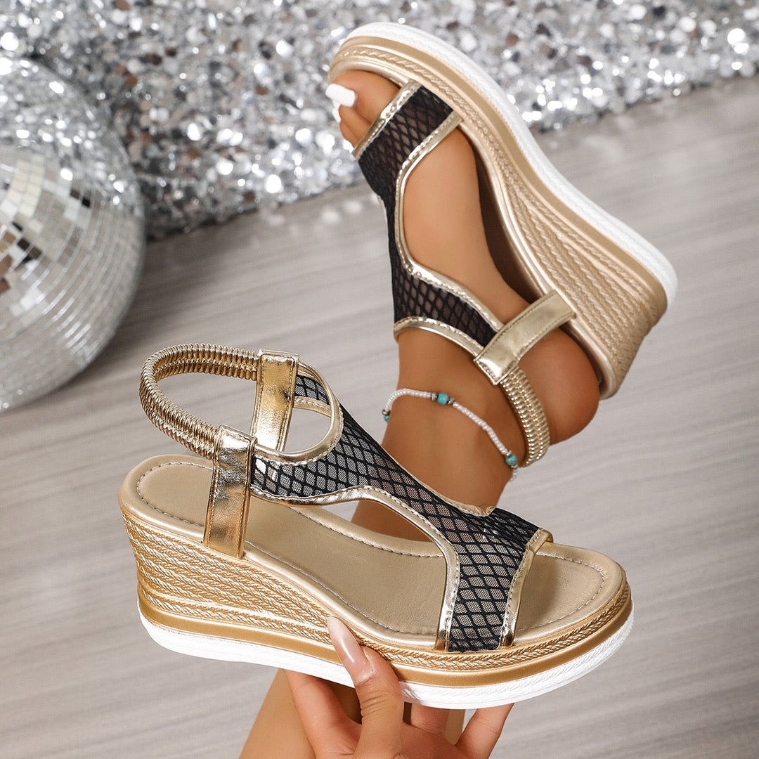 Ergonomic wedge sandals with open toe, black mesh side panels, and gold buckle straps
