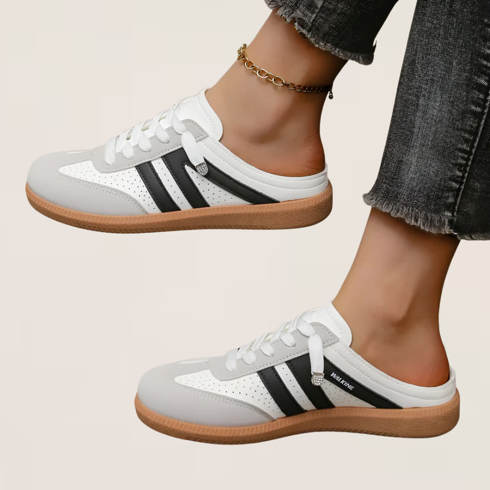 White retro sneakers with black side stripes, low profile, gum sole.