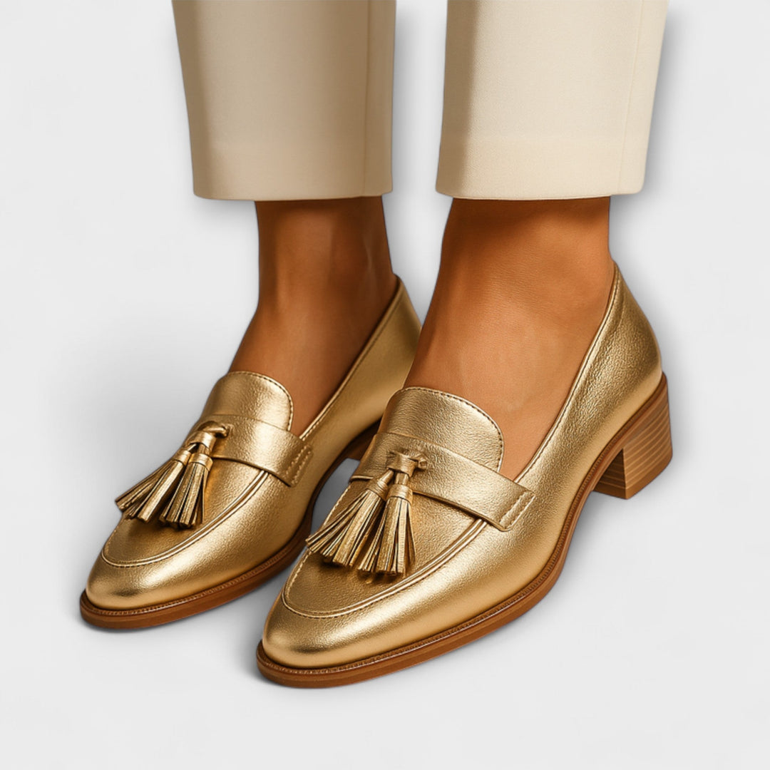 Gold tassel loafers with low block heel and moc-style stitching