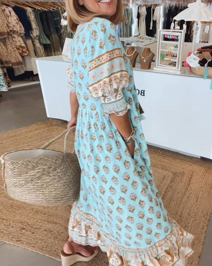Blue floral V-neck tiered midi dress with short ruffle sleeves, side view