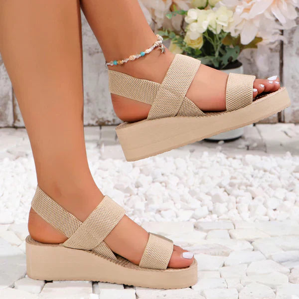 Beige woven platform sandals with wide cross straps and chunky sole