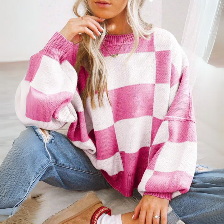 Light pink and white checkered crewneck long-sleeve knit sweater with ribbed cuffs