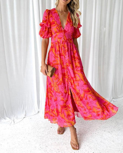 Red and pink patterned maxi dress with puff sleeves and V-neck, flowing skirt