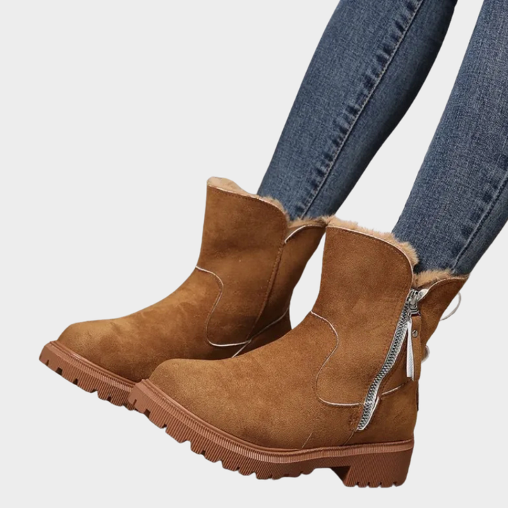 Brown orthopedic boot with faux fur cuff and side zipper on chunky lug sole
