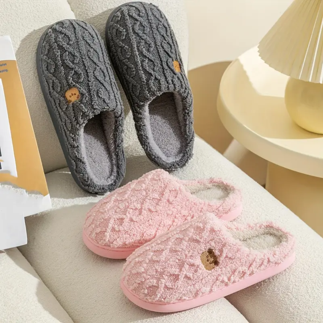 Pair of fuzzy bear print slippers: gray and pink, slip-on with thick cushioned soles