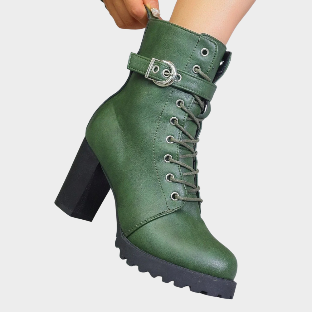 Green flared heel ankle boots with lace-up front, buckle strap, and chunky tread sole