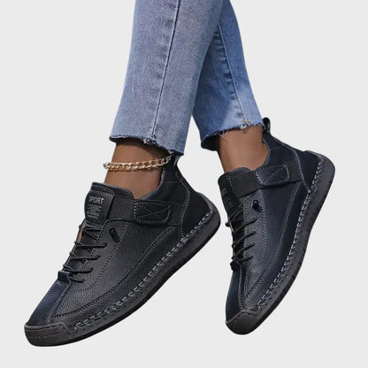 Orthopedic sneakers in black with lace-up front, hook-and-loop strap, and cushioned sole