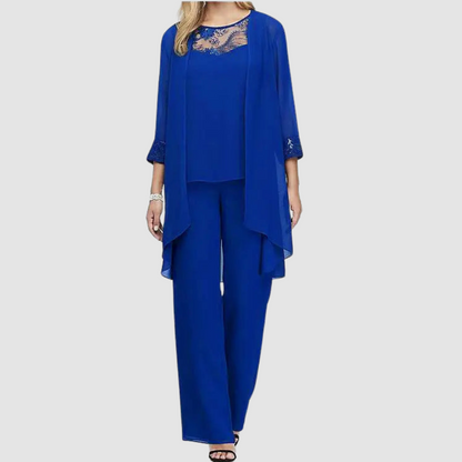 Blue three-piece set: lace-trim top, draped jacket, matching tapered trousers.