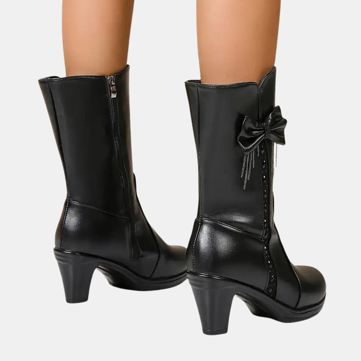 Vintage bow leather boots, black, front view with zipper seam, bow detail, and block heel