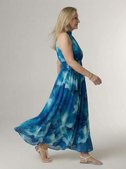 Blue gathered halter midi dress side view with smocked waist and full skirt