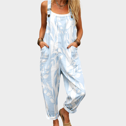 Light blue and white leaf-printed sleeveless overalls with front pockets and button straps