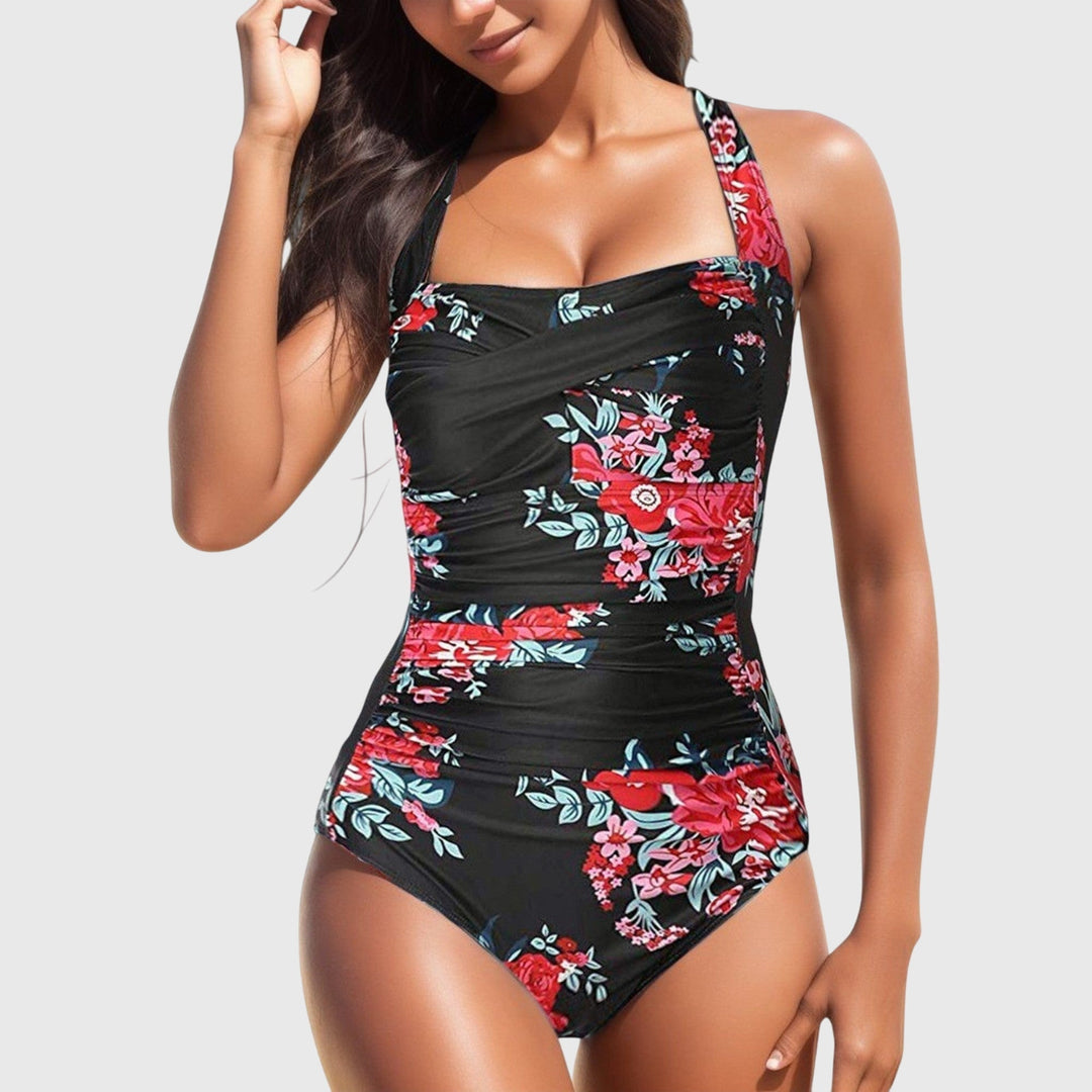 One-piece swimsuit, black with red floral print and side shirred detailing.