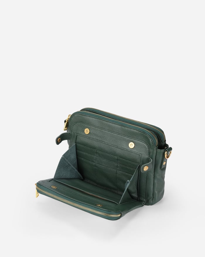 Jovie deep green crossbody bag, open with multiple interior compartments and zip pocket