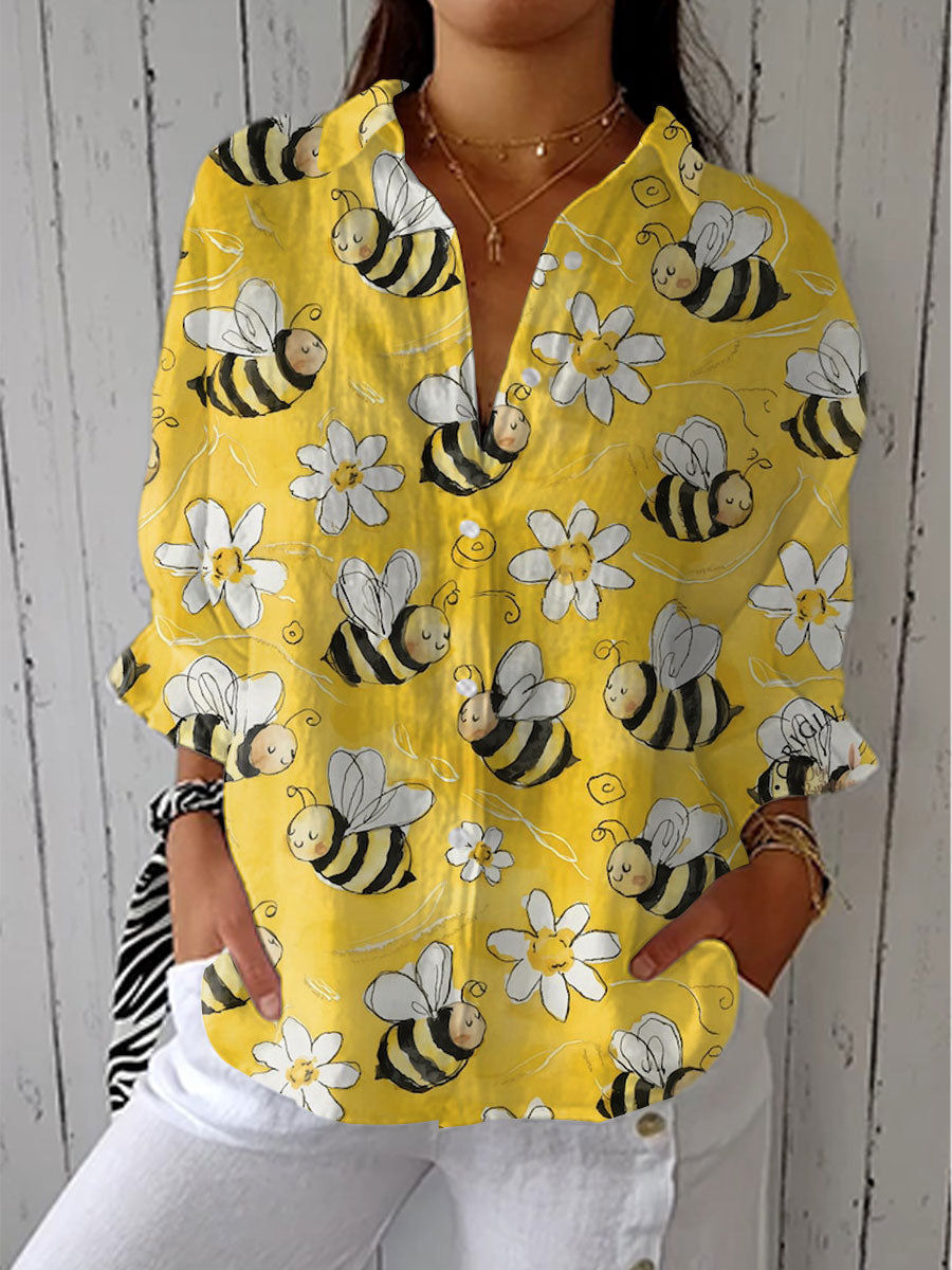 Yellow long-sleeve blouse with button front, V-neck, bee and flower print